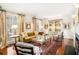 Elegant living room with hardwood floors, a fireplace, and natural light from large windows at 3000 Rivermeade Nw Dr, Atlanta, GA 30327