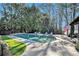 Beautiful backyard pool with an outdoor lounge area and lush landscaping at 3000 Rivermeade Nw Dr, Atlanta, GA 30327