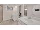 Modern bathroom with double sinks, wood look tile flooring, and a seamless glass shower door at 6441 Se Brookside Blvd, Mableton, GA 30126