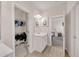 Bright bathroom featuring wood-look tile floors, white cabinets, and a convenient closet for storage at 6441 Se Brookside Blvd, Mableton, GA 30126