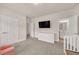 Bedroom with grey carpet features white furniture, a television and a door to bathroom at 6441 Se Brookside Blvd, Mableton, GA 30126