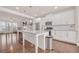 Bright, open kitchen featuring a granite island, white cabinetry, and stainless steel appliances at 6441 Se Brookside Blvd, Mableton, GA 30126