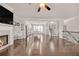 Open-concept living room and kitchen area with hardwood flooring and a fireplace at 6441 Se Brookside Blvd, Mableton, GA 30126