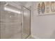 Sleek glass enclosed shower with decorative tile and surf board art provides the upmost relaxation at 6441 Se Brookside Blvd, Mableton, GA 30126