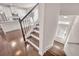 Stylish staircase with dark wood steps leading to the main level, showcasing the home's open floor plan at 6441 Se Brookside Blvd, Mableton, GA 30126