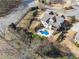 Aerial view of a home with a custom pool, landscaped backyard, and a private fenced yard at 102 Glenmill Way, Woodstock, GA 30188