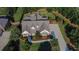 Stunning aerial view of a brick home with a large driveway, mature trees and a well-manicured lawn at 102 Glenmill Way, Woodstock, GA 30188
