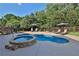 Relaxing pool and spa area with patio and well-maintained landscaping at 102 Glenmill Way, Woodstock, GA 30188