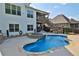 Outdoor pool and spa featuring a stone waterfall and multi-level deck great for entertaining at 102 Glenmill Way, Woodstock, GA 30188