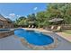 Pool and hot tub surrounded by lush trees and manicured lawn at 102 Glenmill Way, Woodstock, GA 30188