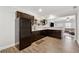 Basement bar with dark wood cabinets, granite counters, and stainless steel refrigerator at 102 Glenmill Way, Woodstock, GA 30188