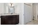 Bathroom features granite countertop, dark wood cabinetry, a framed mirror, and a shower with a patterned curtain at 102 Glenmill Way, Woodstock, GA 30188