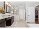 Bright bathroom featuring a glass-enclosed shower, a large mirror, and double doors to walk-in closet at 102 Glenmill Way, Woodstock, GA 30188