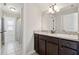 Neutral bath with granite vanity, framed mirror, and tub/shower combination at 102 Glenmill Way, Woodstock, GA 30188