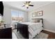 Cozy bedroom with hardwood floors, a large window, and a comfortable bed at 102 Glenmill Way, Woodstock, GA 30188
