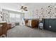 Bedroom with floral wallpaper, crib, and a comfortable chair, creating a cozy and inviting space at 102 Glenmill Way, Woodstock, GA 30188