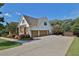 Spacious home featuring a three-car garage and a well-kept lawn at 102 Glenmill Way, Woodstock, GA 30188