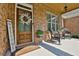 Inviting front porch with a rocking chair and a welcoming wreath on the door at 102 Glenmill Way, Woodstock, GA 30188