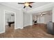Open-concept living room with hardwood floors, recessed lighting, and a pool table in the adjacent room at 102 Glenmill Way, Woodstock, GA 30188