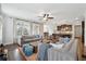 Bright living room boasts hardwood floors, neutral walls, and stylish furniture and flows to the kitchen at 102 Glenmill Way, Woodstock, GA 30188
