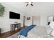 The bright main bedroom is a serene retreat with a vaulted ceiling, tv and an ensuite at 102 Glenmill Way, Woodstock, GA 30188