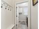 Mud room with coat rack, bench, and access to the laundry room at 102 Glenmill Way, Woodstock, GA 30188