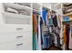Spacious walk-in closet featuring custom built-in shelving and drawers for organized storage solutions at 102 Glenmill Way, Woodstock, GA 30188