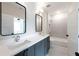 Double vanity bathroom with white countertops, modern fixtures, and a tiled shower/bath at 158 Palisade Dr, Rydal, GA 30171