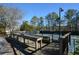 A viewing deck near the tennis court offers a shaded area for enjoying watching tennis matches at 201 Saint Andrews Ct, Alpharetta, GA 30022