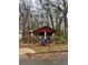 Red single-story home with a fenced front yard on a cloudy day at 3230 Altacrest Dr, Scottdale, GA 30079