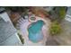 An aerial view of a backyard featuring a pool, a lounge area, and a jacuzzi, surrounded by trees at 350 Lockwood Terrace, Decatur, GA 30030