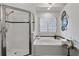 Bright bathroom features a glass enclosed shower, a soaking tub and black and white tile at 350 Lockwood Terrace, Decatur, GA 30030