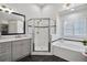 Bright bathroom features a glass enclosed shower, a soaking tub and black and white tile at 350 Lockwood Terrace, Decatur, GA 30030