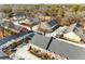 Aerial view of the townhome complex with pool, trees, and city view in the distance at 307 Adair St # 7-E, Decatur, GA 30030