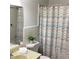 Bathroom with a shower and tub combination, white and blue patterned shower curtain and modern vanity at 307 Adair St # 7-E, Decatur, GA 30030
