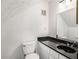 Cozy bathroom featuring a black marble countertop and updated fixtures at 307 Adair St # 7-E, Decatur, GA 30030