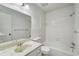 Bright bathroom with a marble vanity, tub and shower combination, and tile surround at 307 Adair St # 7-E, Decatur, GA 30030