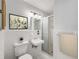 Bright bathroom featuring a sleek shower, pedestal sink, and tiled walls at 307 Adair St # 7-E, Decatur, GA 30030