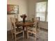 Dining room with a round table, four chairs, and natural light from a nearby window at 307 Adair St # 7-E, Decatur, GA 30030