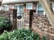 Close-up of a brick wall, wrought iron gate, and 'Come In We're Open' sign at 307 Adair St # 7-E, Decatur, GA 30030