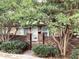 Charming brick townhouse featuring a quaint gate and lush greenery enhancing curb appeal at 307 Adair St # 7-E, Decatur, GA 30030