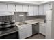 This open-concept kitchen features stainless steel appliances and white cabinets at 307 Adair St # 7-E, Decatur, GA 30030