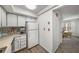 Bright kitchen features white cabinets, countertops, and appliances, accented by a decorative backsplash at 307 Adair St # 7-E, Decatur, GA 30030