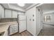 Bright kitchen features white cabinets, countertops, and appliances, accented by a decorative backsplash at 307 Adair St # 7-E, Decatur, GA 30030