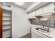 Efficient kitchen with stainless steel sink, ample storage, and backsplash at 307 Adair St # 7-E, Decatur, GA 30030