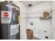 Practical laundry area featuring a Rheem water heater and convenient wire shelving for organized storage at 307 Adair St # 7-E, Decatur, GA 30030