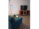Inviting living room setup with a cozy armchair and contemporary entertainment unit at 307 Adair St # 7-E, Decatur, GA 30030