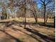 Park with shady trees, benches, and a play structure in the distance at 307 Adair St # 7-E, Decatur, GA 30030