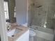 Updated bathroom features granite countertops and a shower over tub with glass door at 6832 Shangrila Way, Riverdale, GA 30296