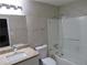 Bathroom featuring a shower over tub with sliding glass door at 6832 Shangrila Way, Riverdale, GA 30296